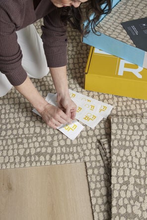 FLOR area rug being installed tile by tile